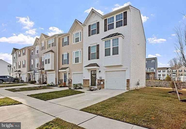 view of property with a garage, a residential view, concrete driveway, and a front lawn