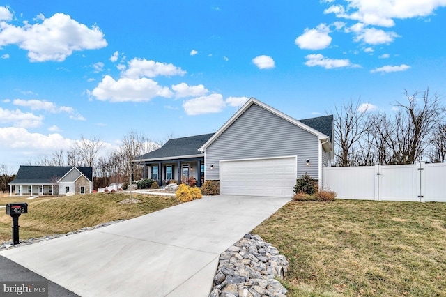 ranch-style home featuring concrete driveway, an attached garage, a front yard, a gate, and fence