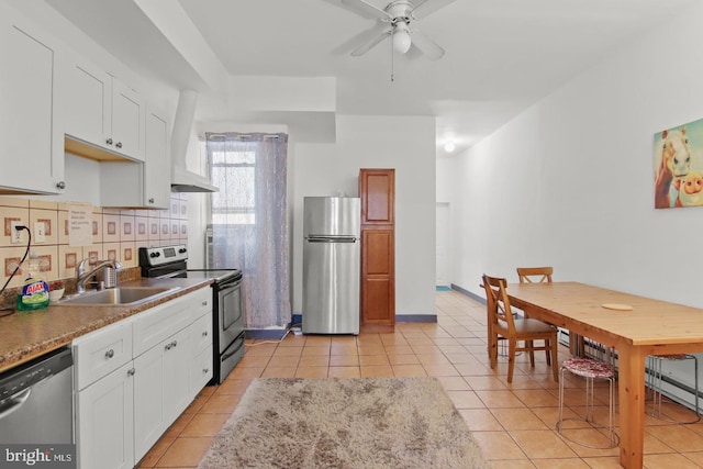 3823 Poplar St, Philadelphia, PA 19104 - kitchen featuring custom range hood, a sink, appliances with stainless steel finishes, light tile patterned floors, and decorative backsplash