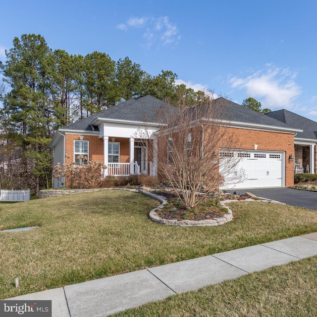 view of front facade with driveway, a garage, a porch, a front lawn, and brick siding