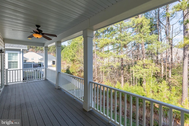 wooden terrace featuring ceiling fan