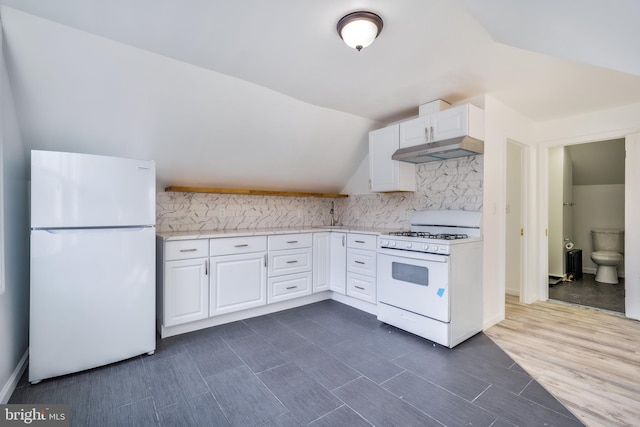 kitchen featuring white appliances, light countertops, decorative backsplash, and white cabinets