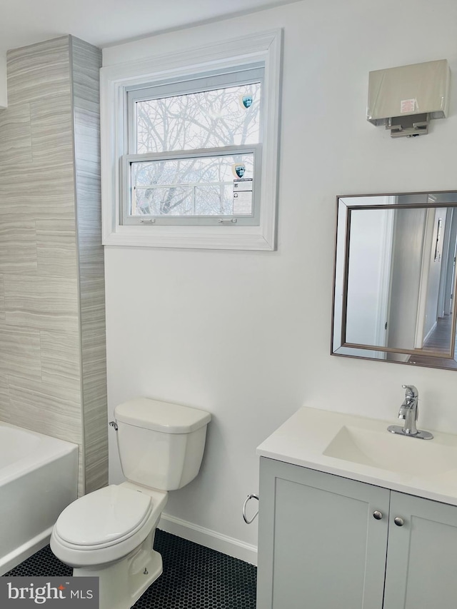 full bath with toilet, vanity, baseboards, a bath, and tile patterned floors