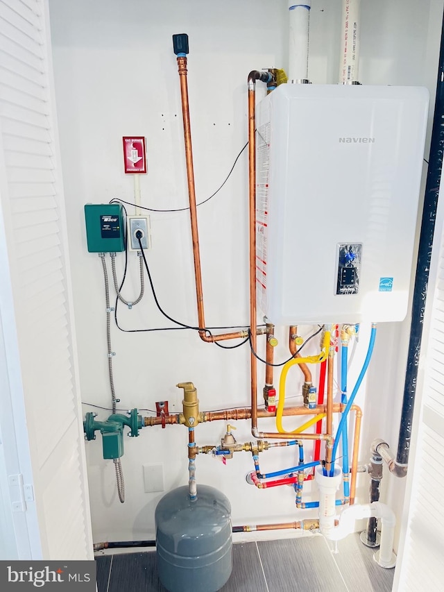 utility room featuring water heater