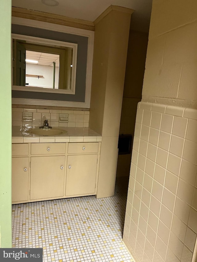 bathroom with tile patterned floors, vanity, and tile walls