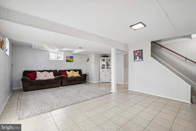 living room with stairway and light tile patterned flooring