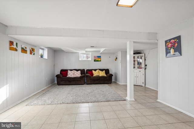 living room featuring light tile patterned floors, visible vents, and a wealth of natural light