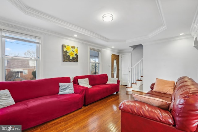 living area featuring recessed lighting, crown molding, stairs, and hardwood / wood-style flooring