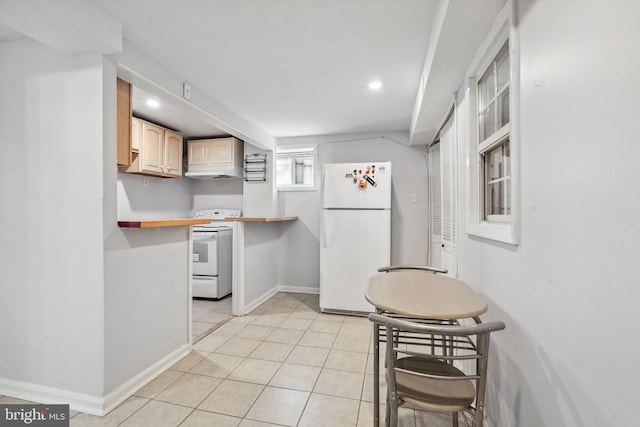 kitchen with under cabinet range hood, recessed lighting, white appliances, light tile patterned floors, and baseboards