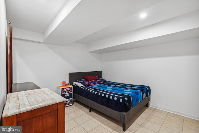 bedroom featuring light tile patterned floors and baseboards