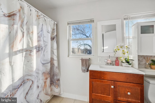 bathroom featuring baseboards, vanity, and tile patterned flooring