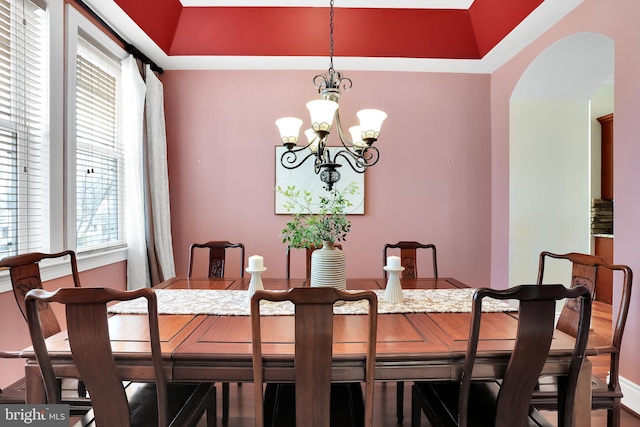 dining room with a chandelier and arched walkways