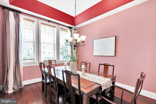 dining room featuring baseboards, dark wood-type flooring, and an inviting chandelier