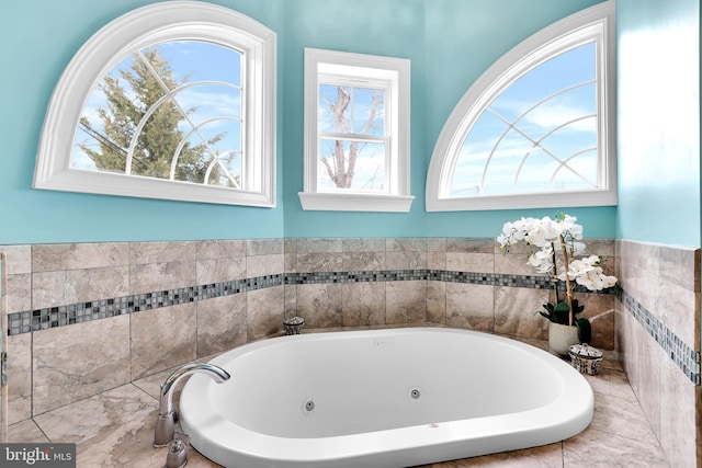 bathroom featuring a tub with jets