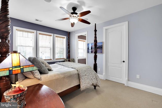 carpeted bedroom featuring baseboards, visible vents, and a ceiling fan