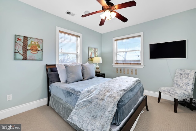 bedroom with carpet floors, multiple windows, and visible vents