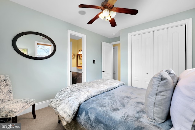 carpeted bedroom with a ceiling fan, a closet, and baseboards