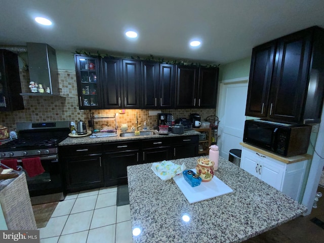3227 Woodring Ave, Baltimore, MD 21234 - kitchen featuring stainless steel gas range, black microwave, backsplash, and wall chimney exhaust hood
