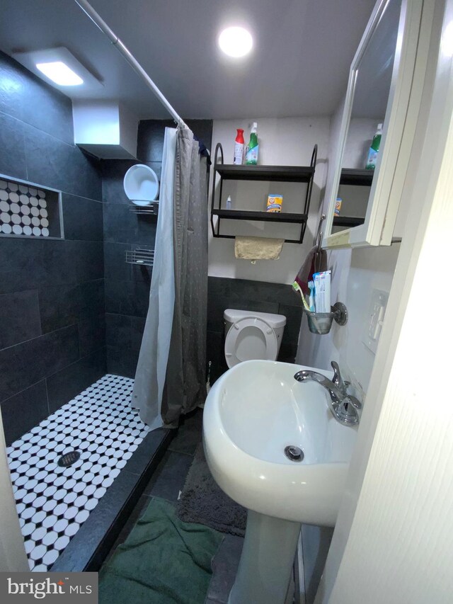 3227 Woodring Ave, Baltimore, MD 21234 - bathroom with a sink, a shower stall, and toilet
