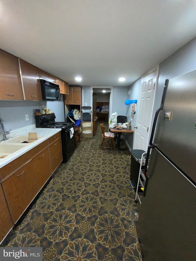 3227 Woodring Ave, Baltimore, MD 21234 - kitchen with recessed lighting, stone finish flooring, light countertops, and black appliances