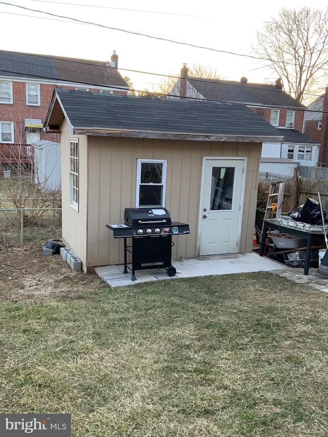 view of shed featuring fence