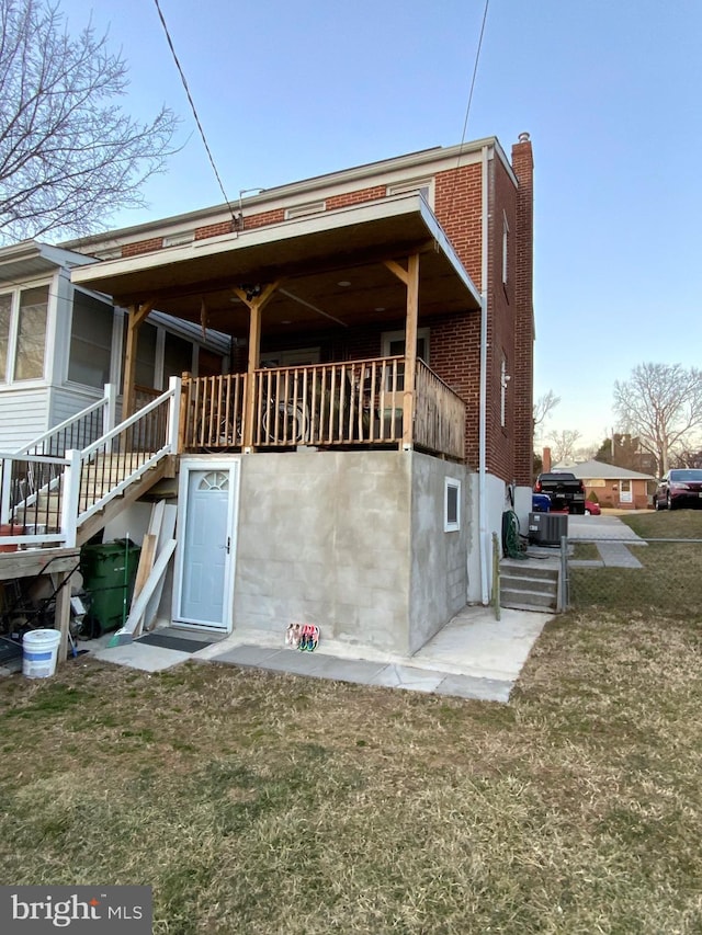 3227 Woodring Ave, Baltimore, MD 21234 - view of side of property featuring brick siding, a lawn, and stairway