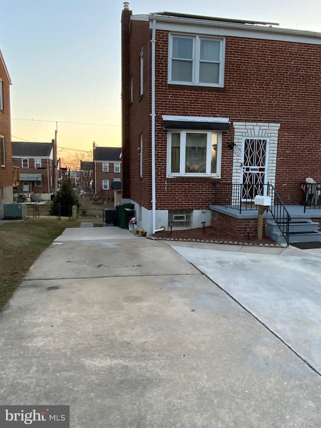 3227 Woodring Ave, Baltimore, MD 21234 - view of front facade with a chimney and brick siding