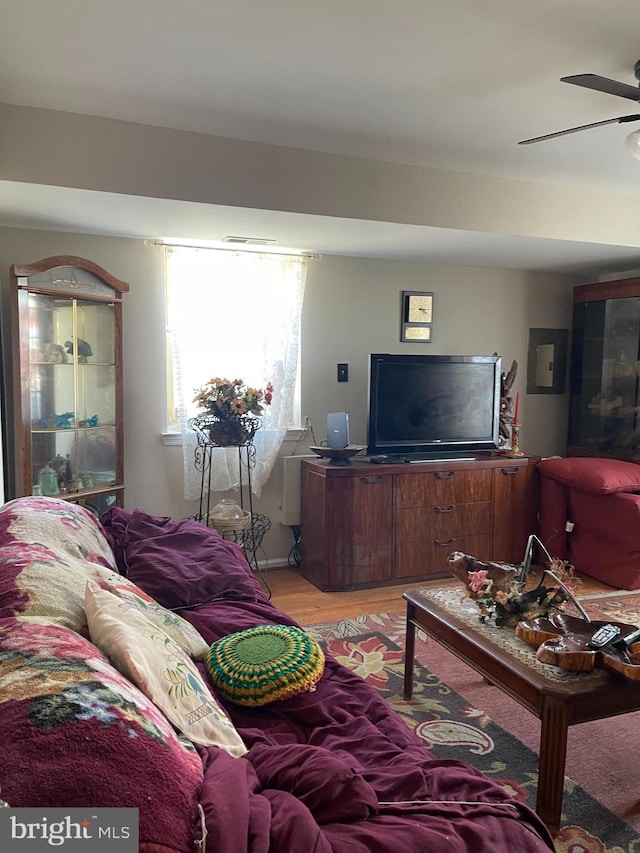 living area with light wood-style floors and ceiling fan