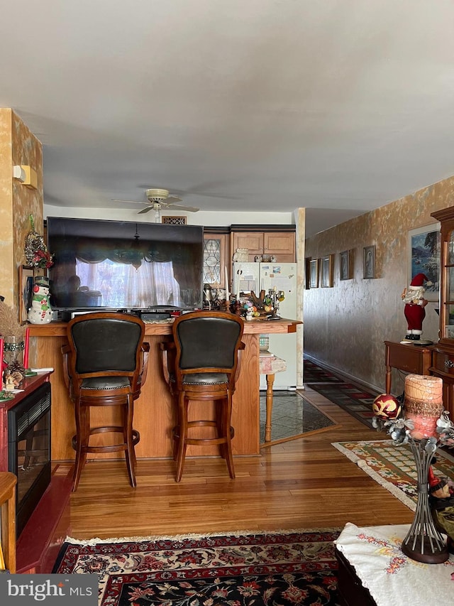 dining area with a ceiling fan and wood finished floors