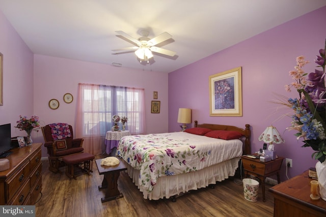 bedroom with dark wood finished floors, visible vents, and a ceiling fan