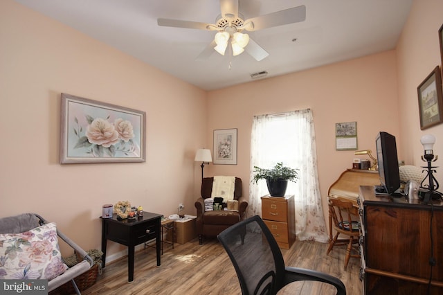 office featuring wood finished floors, visible vents, and a ceiling fan