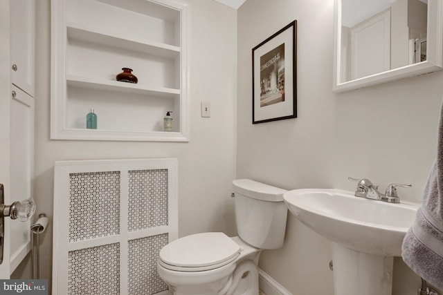 bathroom featuring toilet and radiator heating unit