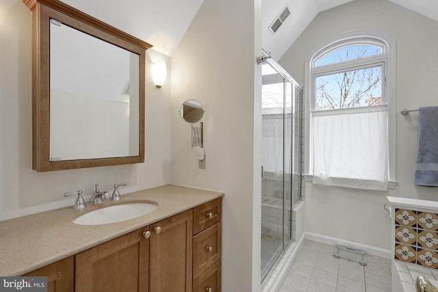 bathroom featuring tile patterned floors, visible vents, lofted ceiling, and a shower stall