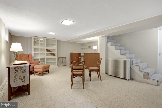 interior space featuring radiator, a textured ceiling, and stairs