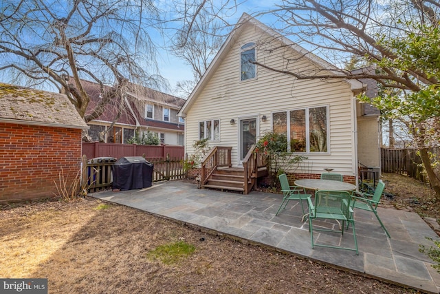 rear view of house with a patio area and a fenced backyard