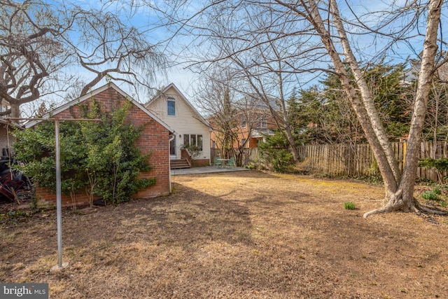 view of yard featuring entry steps, a patio area, and fence