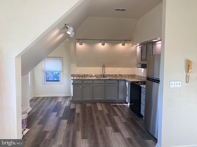 kitchen featuring black electric range, dark wood finished floors, visible vents, freestanding refrigerator, and a sink