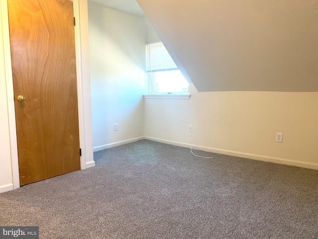 bonus room with lofted ceiling, baseboards, and carpet flooring