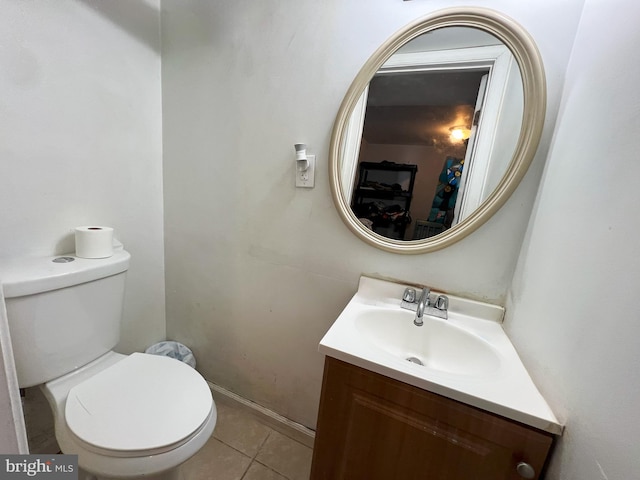 bathroom featuring toilet, tile patterned flooring, and vanity