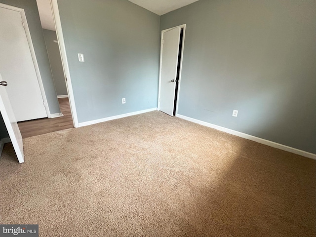 unfurnished bedroom featuring baseboards and carpet flooring