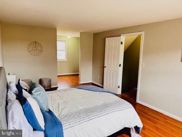 bedroom with wood finished floors and baseboards