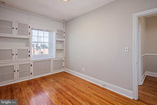 interior space featuring light wood finished floors and baseboards