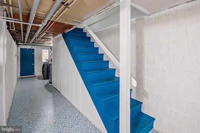 stairway featuring speckled floor