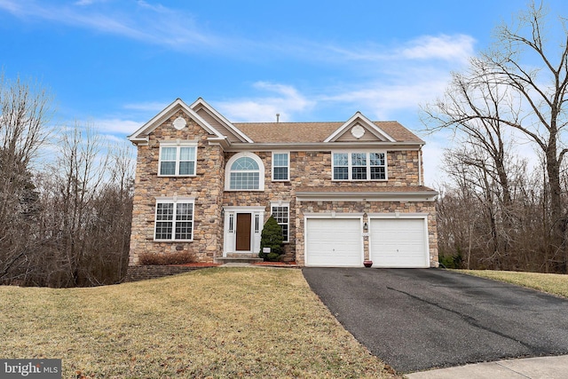 traditional-style home with a garage, roof with shingles, driveway, and a front lawn