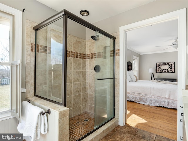 ensuite bathroom with wood finished floors, ensuite bath, a shower stall, crown molding, and ceiling fan