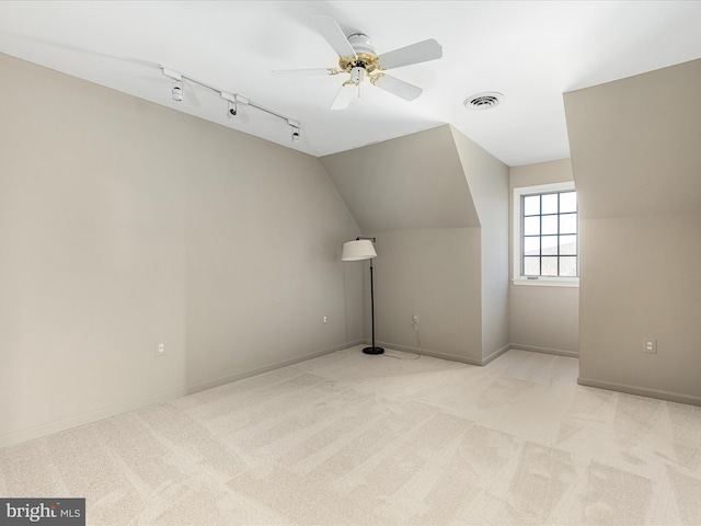 bonus room featuring visible vents, baseboards, light colored carpet, ceiling fan, and vaulted ceiling