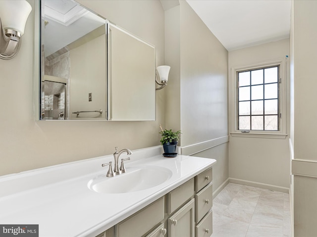 full bath featuring baseboards, tiled shower, and vanity