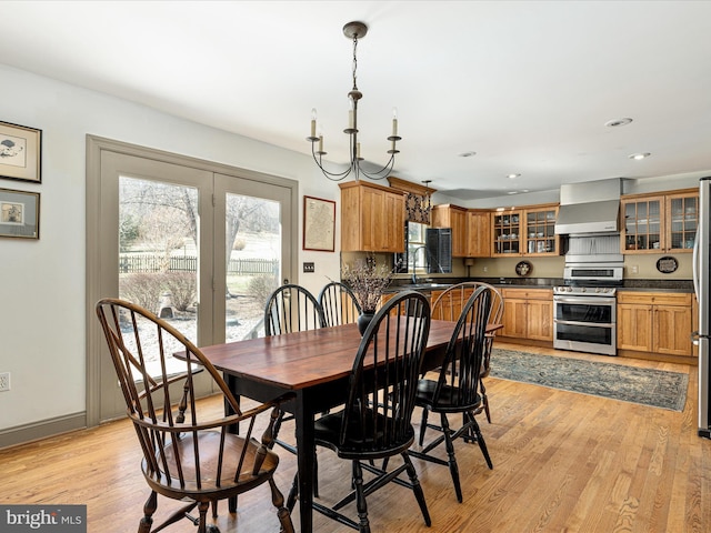 dining space featuring recessed lighting, baseboards, and light wood-style floors