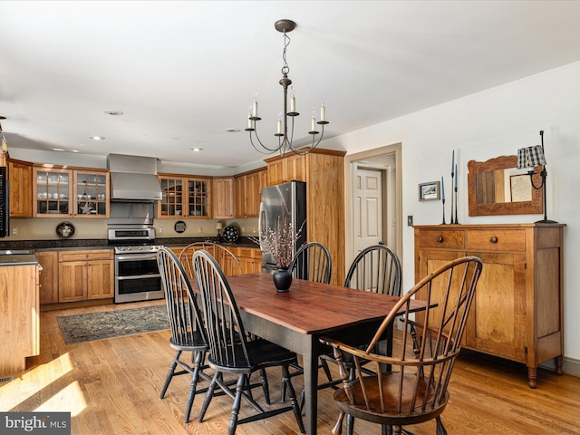 dining area featuring an inviting chandelier, recessed lighting, and light wood finished floors