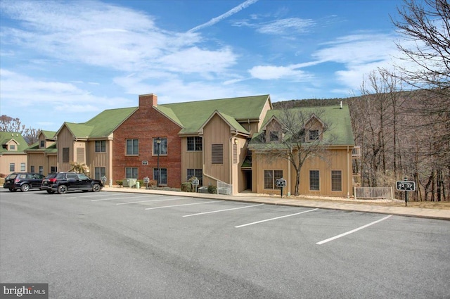 view of building exterior featuring uncovered parking